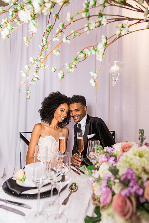  Las Vegas wedding with purple details and the bride in a strapless gown and the groom in a black velvet tuxedo 