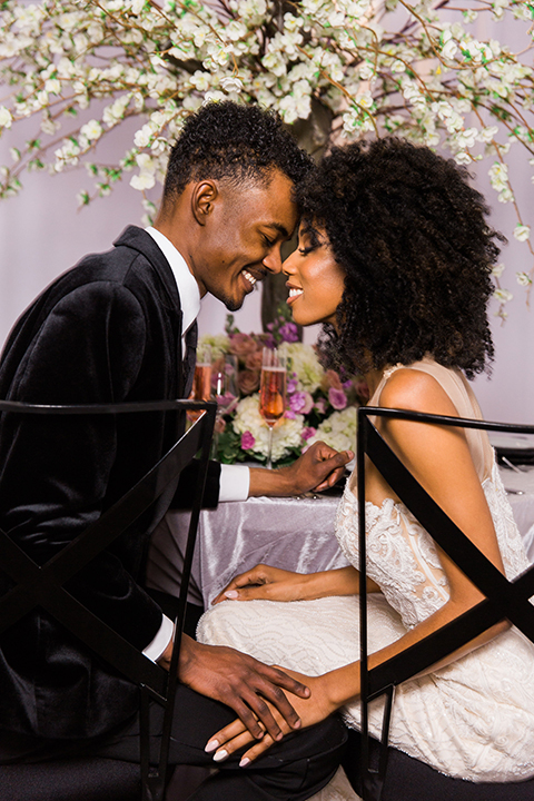  Las Vegas wedding with purple details and the bride in a strapless gown and the groom in a black velvet tuxedo 