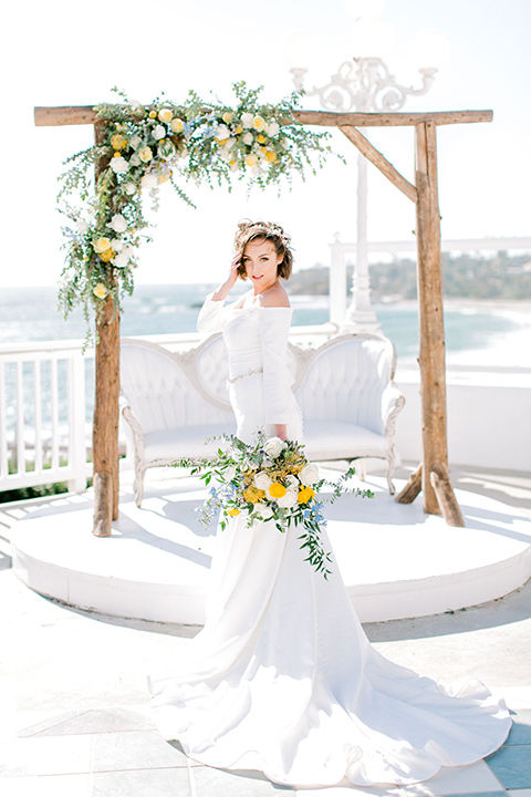  beach style wedding with the groom in a café brown coat and navy pant 