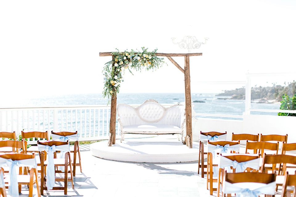  beach style wedding with the groom in a café brown coat and navy pant 