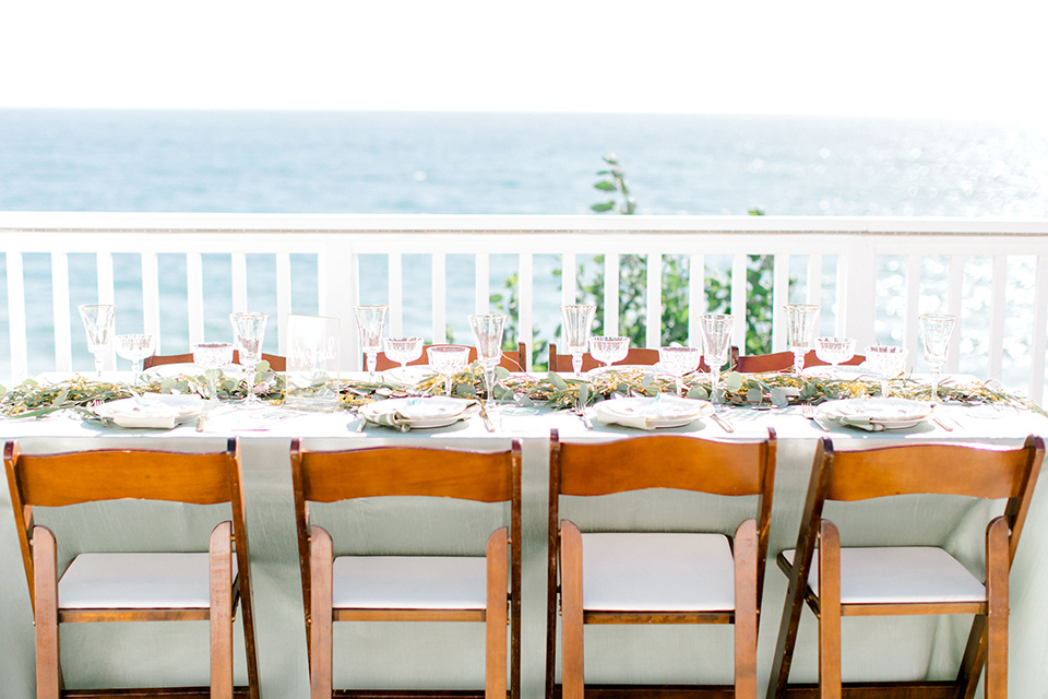  beach style wedding with the groom in a café brown coat and navy pant 