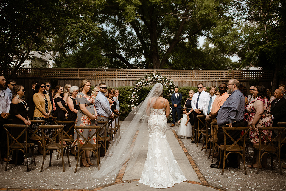  a romantic church wedding with the groom and groomsmen in cobalt blue suit and the bridesmaids in blush and the bride in a lace fitted gown 