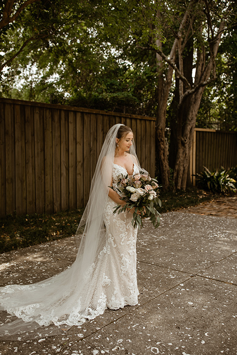  a romantic church wedding with the groom and groomsmen in cobalt blue suit and the bridesmaids in blush and the bride in a lace fitted gown 