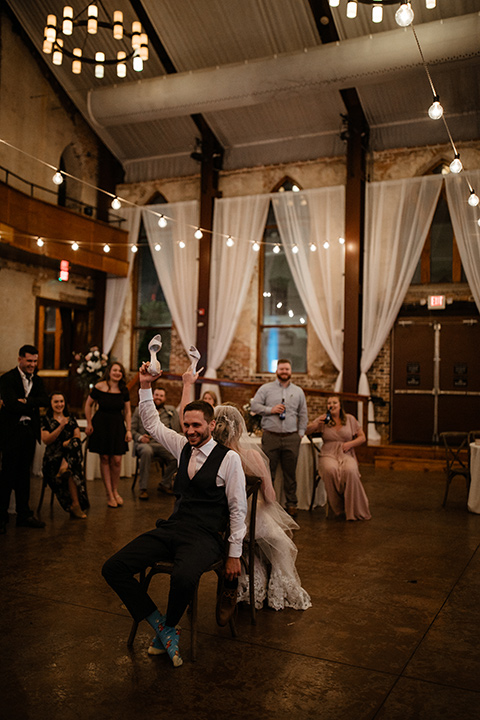  a romantic church wedding with the groom and groomsmen in cobalt blue suit and the bridesmaids in blush and the bride in a lace fitted gown 