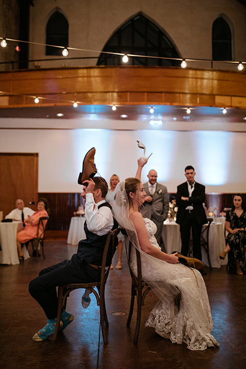  a romantic church wedding with the groom and groomsmen in cobalt blue suit and the bridesmaids in blush and the bride in a lace fitted gown 