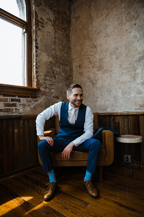  a romantic church wedding with the groom and groomsmen in cobalt blue suit and the bridesmaids in blush and the bride in a lace fitted gown 