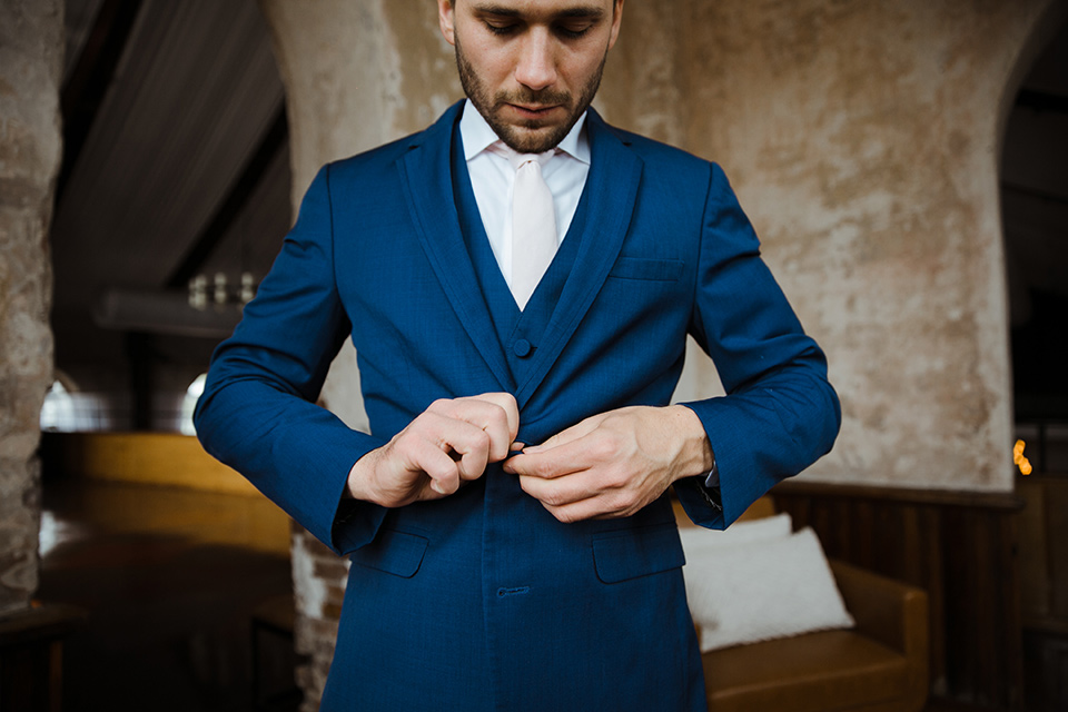  a romantic church wedding with the groom and groomsmen in cobalt blue suit and the bridesmaids in blush and the bride in a lace fitted gown 