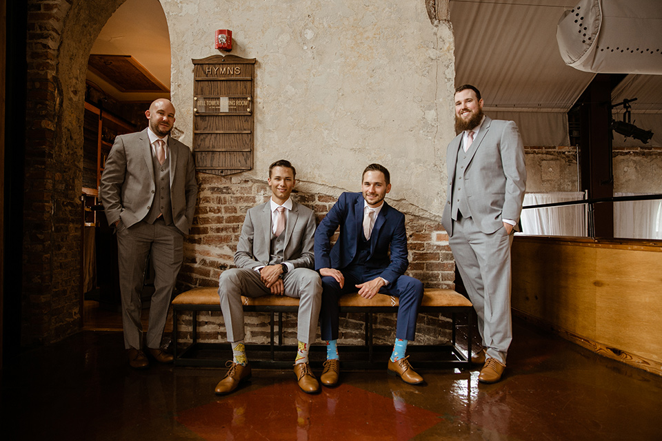  a romantic church wedding with the groom and groomsmen in cobalt blue suit and the bridesmaids in blush and the bride in a lace fitted gown 