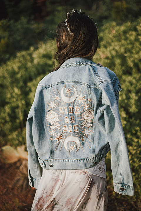  Sedona elopement with bohemian flare – the groom in a green suit and the bride in a boho dress and jean jacket 