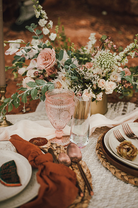  Sedona elopement with bohemian flare – the groom in a green suit and the bride in a boho dress and jean jacket 