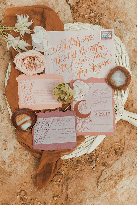  Sedona elopement with bohemian flare – the groom in a green suit and the bride in a boho dress and jean jacket 