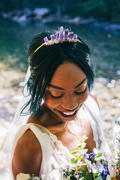  boho wedding with the ceremony inside and the reception on the cliffs overlooking the ocean and the bride in a finged gown and the groom in a tan suit 