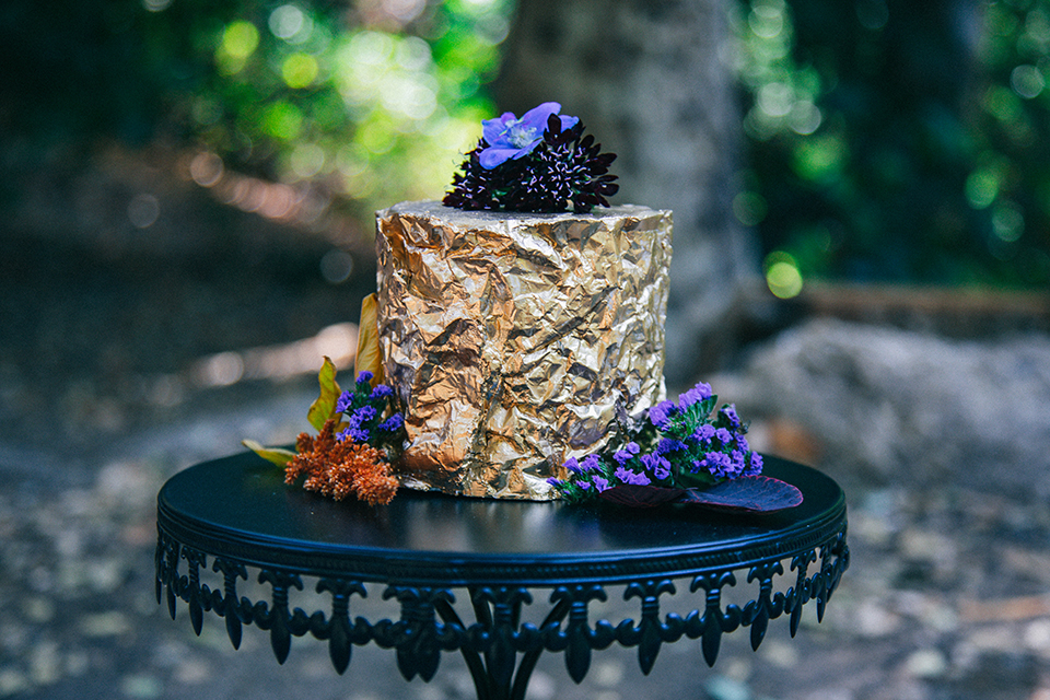  boho wedding with the ceremony inside and the reception on the cliffs overlooking the ocean and the bride in a finged gown and the groom in a tan suit 