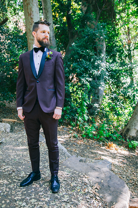  boho wedding with the ceremony inside and the reception on the cliffs overlooking the ocean and the bride in a finged gown and the groom in a tan suit 