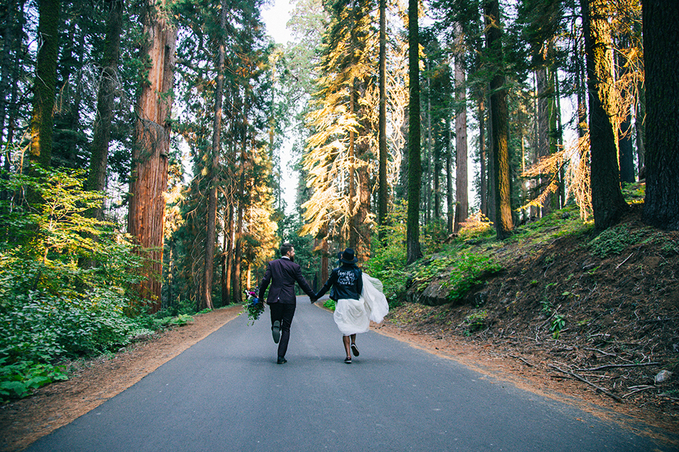  boho wedding with the ceremony inside and the reception on the cliffs overlooking the ocean and the bride in a finged gown and the groom in a tan suit 