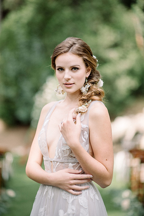  garden themed wedding with the bride in a light lilac colored gown and the groom in a navy suit with lots of wedding day flowers