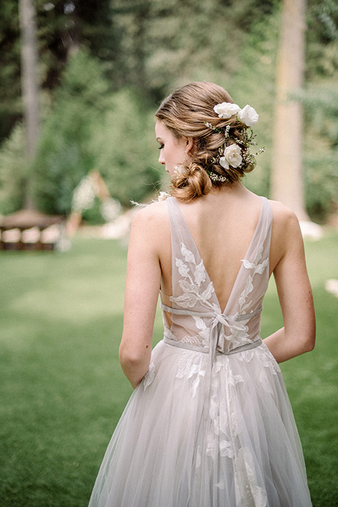  garden themed wedding with the bride in a light lilac colored gown and the groom in a navy suit with lots of wedding day flowers 