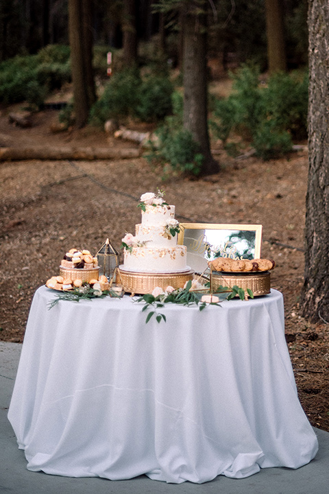  garden themed wedding with the bride in a light lilac colored gown and the groom in a navy suit with lots of wedding day flowers 