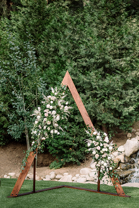  garden themed wedding with the bride in a light lilac colored gown and the groom in a navy suit with lots of wedding day flowers