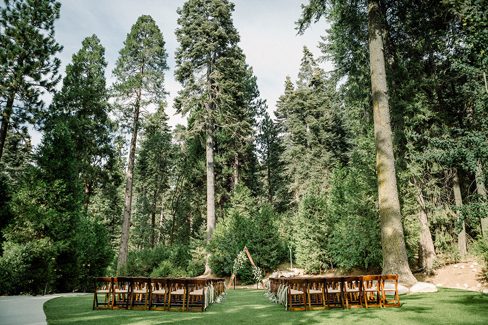  garden themed wedding with the bride in a light lilac colored gown and the groom in a navy suit with lots of wedding day flowers 