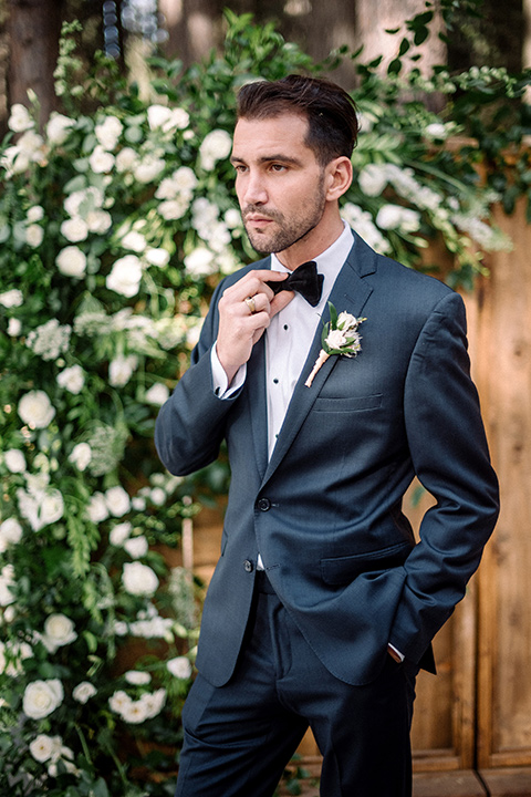  garden themed wedding with the bride in a light lilac colored gown and the groom in a navy suit with lots of wedding day flowers