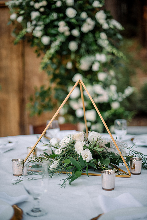  garden themed wedding with the bride in a light lilac colored gown and the groom in a navy suit with lots of wedding day flowers