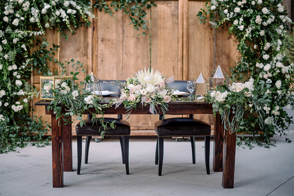  garden themed wedding with the bride in a light lilac colored gown and the groom in a navy suit with lots of wedding day flowers 