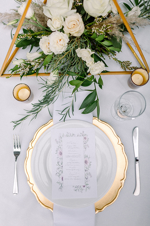  garden themed wedding with the bride in a light lilac colored gown and the groom in a navy suit with lots of wedding day flowers 