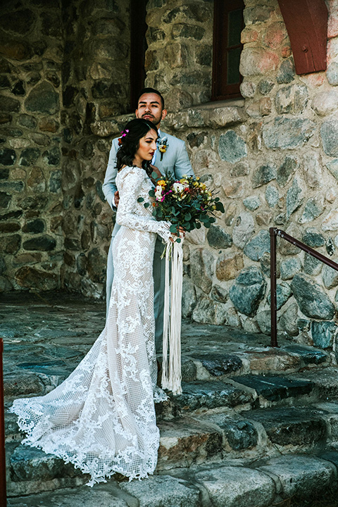  bohemian wedding at a fish hatchery and the bride in a rue de sine gown and the groom in a light grey suit 