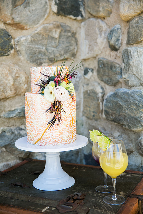  bohemian wedding at a fish hatchery and the bride in a rue de sine gown and the groom in a light grey suit 