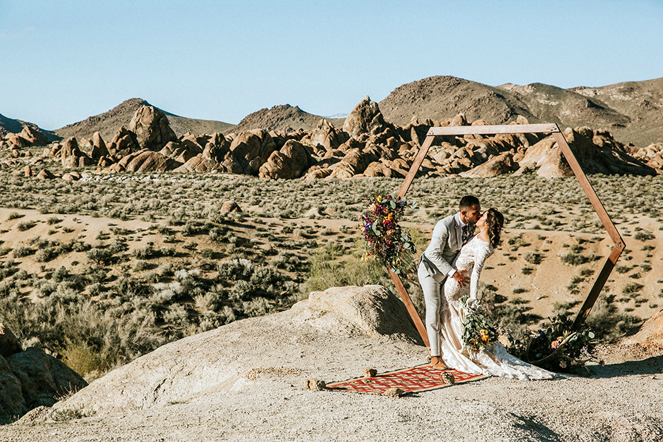  bohemian wedding at a fish hatchery and the bride in a rue de sine gown and the groom in a light grey suit 