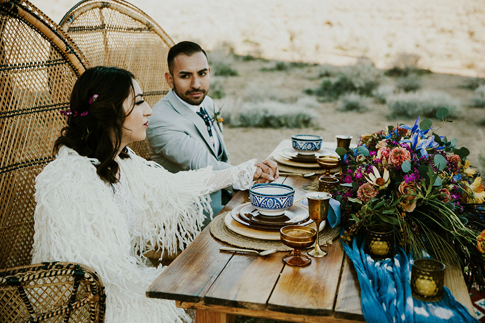  bohemian wedding at a fish hatchery and the bride in a rue de sine gown and the groom in a light grey suit 