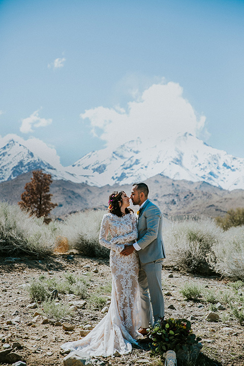  bohemian wedding at a fish hatchery and the bride in a rue de sine gown and the groom in a light grey suit 