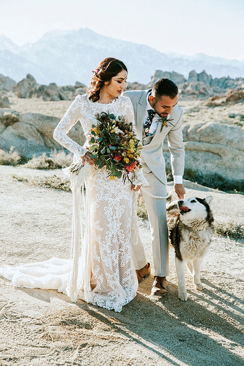  bohemian wedding at a fish hatchery and the bride in a rue de sine gown and the groom in a light grey suit 