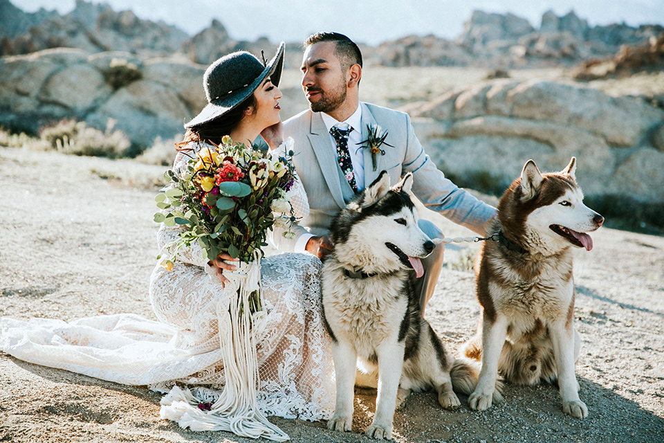  bohemian wedding at a fish hatchery and the bride in a rue de sine gown and the groom in a light grey suit 