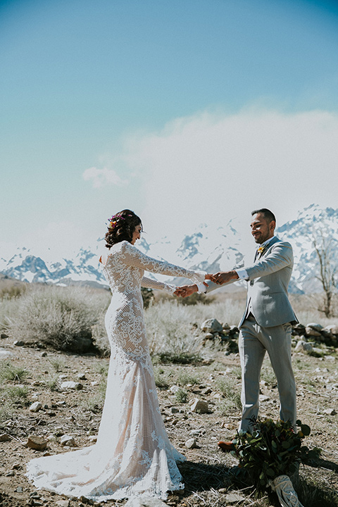  bohemian wedding at a fish hatchery and the bride in a rue de sine gown and the groom in a light grey suit 