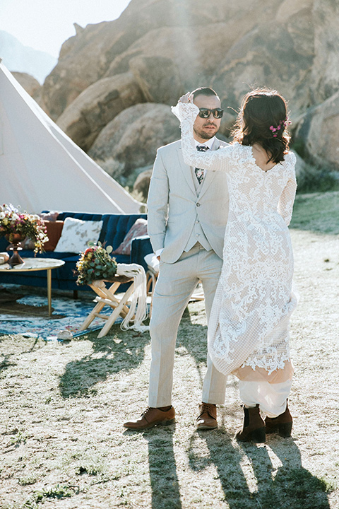  bohemian wedding at a fish hatchery and the bride in a rue de sine gown and the groom in a light grey suit 