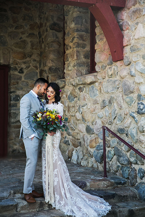  bohemian wedding at a fish hatchery and the bride in a rue de sine gown and the groom in a light grey suit 