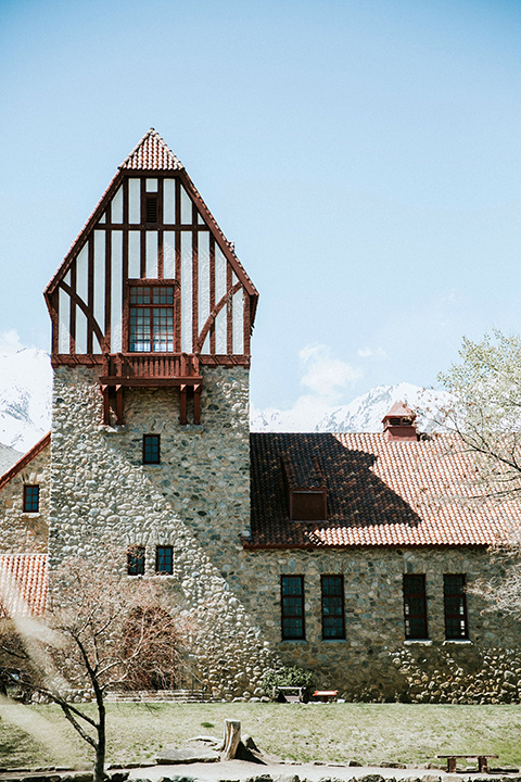  bohemian wedding at a fish hatchery and the bride in a rue de sine gown and the groom in a light grey suit 