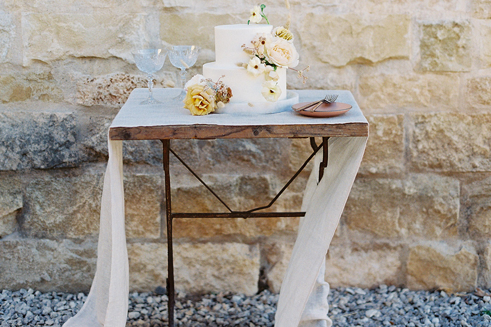  wedding at sunstone winery with romantic details and the groom in a café brown suit and the bride in a flowing ballgown with billowing sleeves 