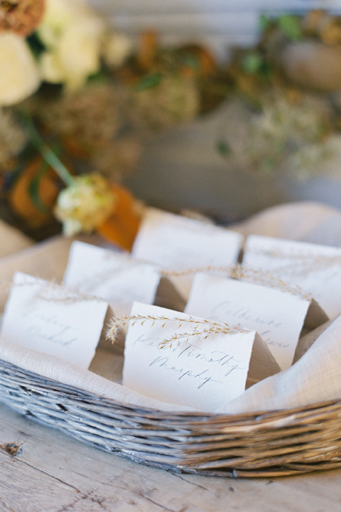  wedding at sunstone winery with romantic details and the groom in a café brown suit and the bride in a flowing ballgown with billowing sleeves