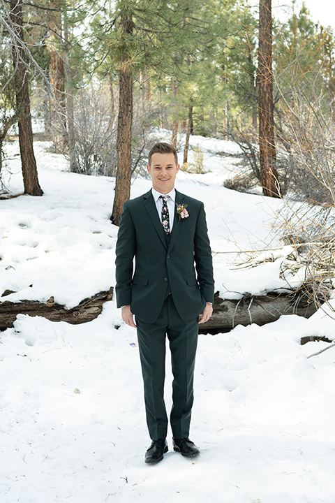  big bear elopement in the snow with the bride is a lace gown and the groom in a green suit – groom in suit