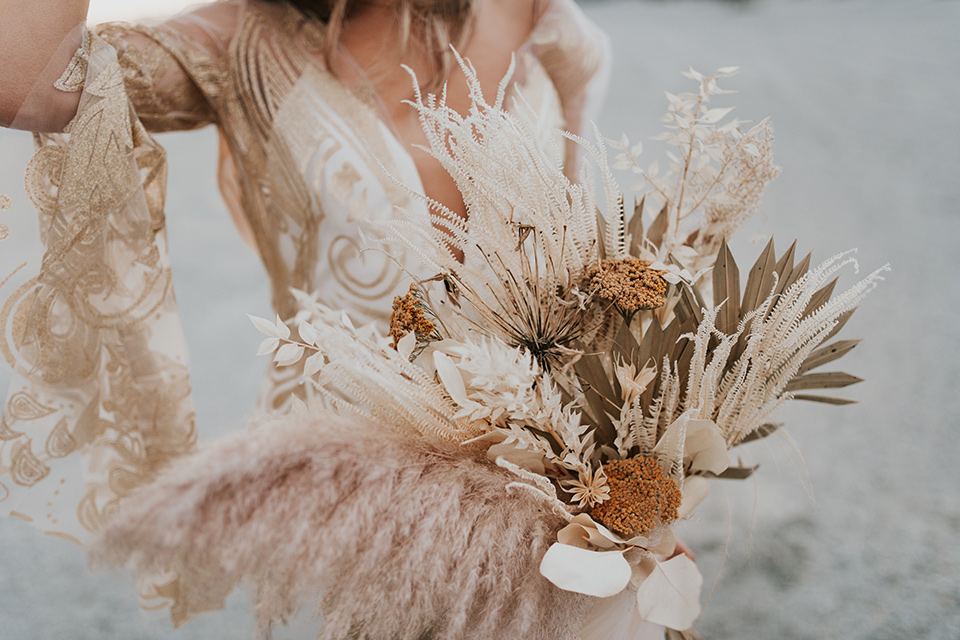  eloping in the desert with a bohemian vibe – bride in a lace gown and the groom in a caramel brown suit – bride close up 
