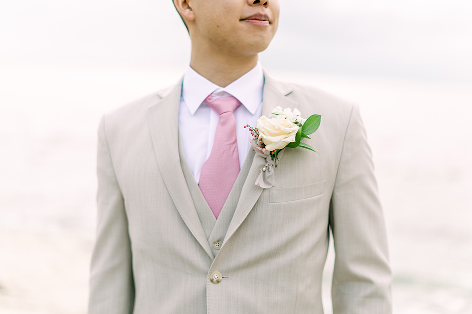  a coastal beach theme with a blush and beige wedding color scheme – groom close up