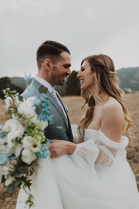  couple laughing at their elopement in a meadow in Colorado