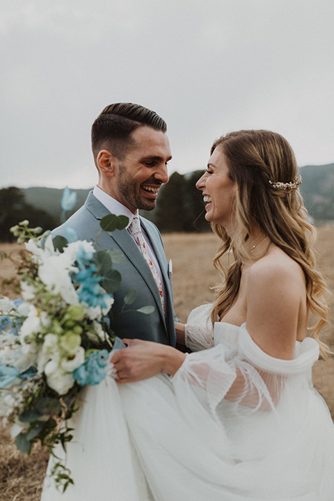  couple laughing at their elopement in a meadow in Colorado 