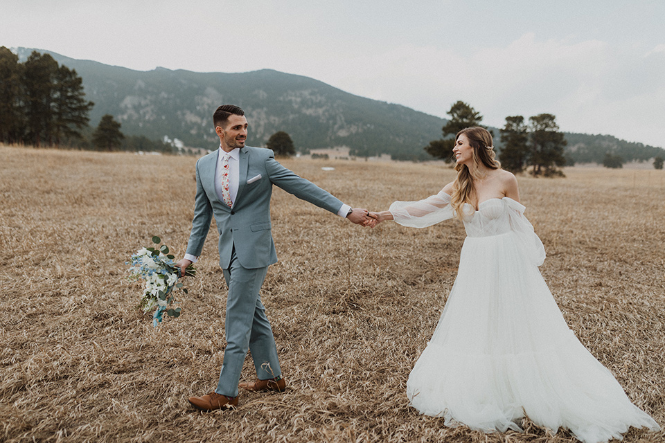  couple laughing at their elopement in a meadow in Colorado 