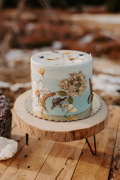  grand tetons elopement in the winter with snow on the ground with the bride in a lace gown and the groom in a rose pink suit – cake