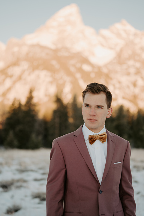  grand tetons elopement in the winter with snow on the ground with the bride in a lace gown and the groom in a rose pink suit – groom