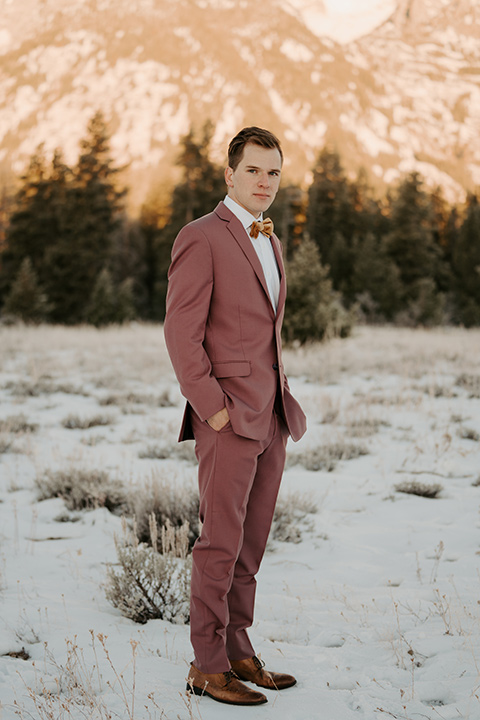  grand tetons elopement in the winter with snow on the ground with the bride in a lace gown and the groom in a rose pink suit – groom 
